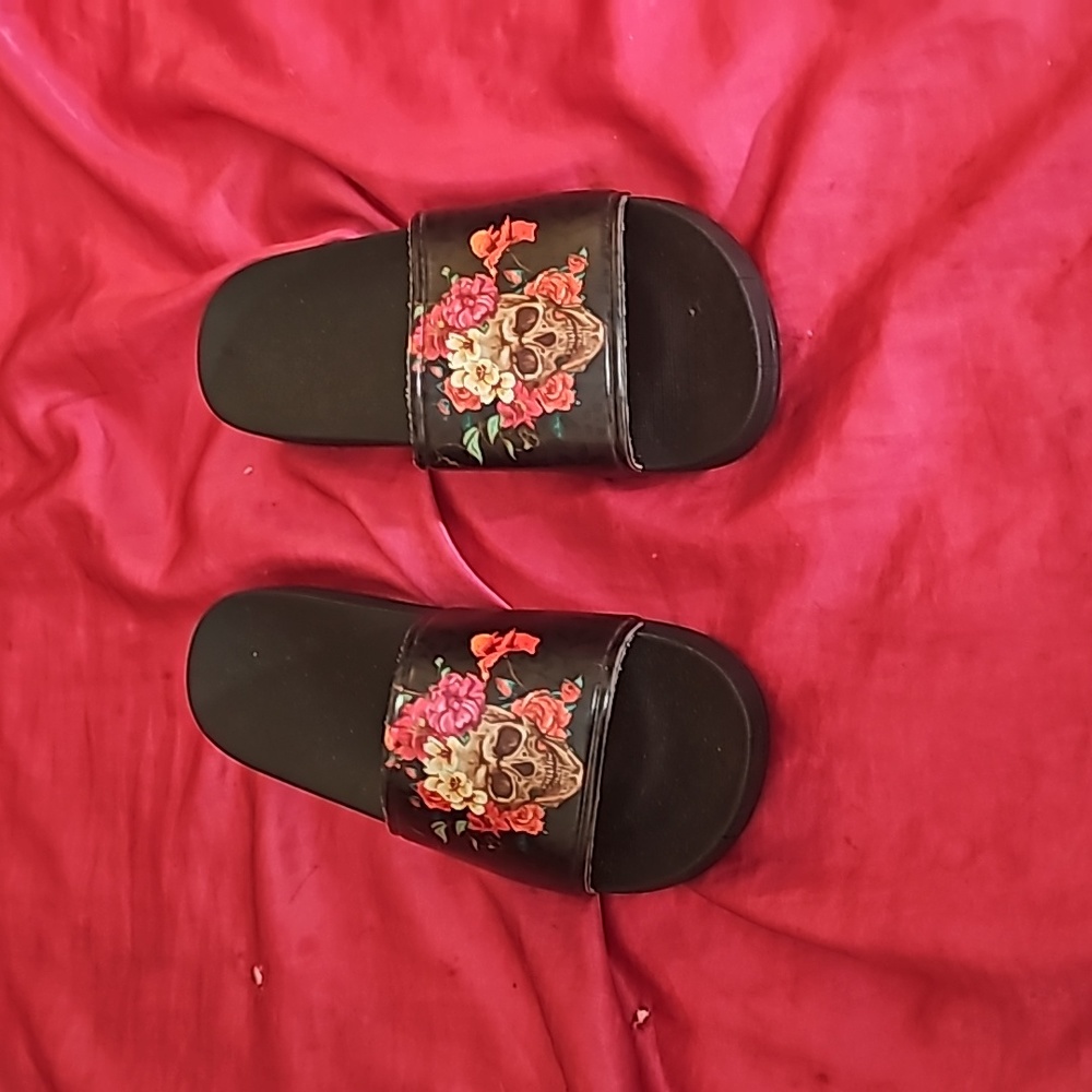 Never worn slides with skulls and flowers.